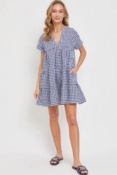 50% cotton and 50% polyester  Navy  Small, medium, large  Mini Dress  Relaxed Fit  V-Neckline  Tiered Skirt  Flowy    Product Details:   Comfortable All-Day Wear: Our Bodydoll Gingham Dress is tailored for maximum comfort, allowing you to wear it from morning to night with ease.  Quality Craftsmanship: Each piece is expertly stitched and quality-checked to ensure it meets the highest standards.  Care Instructions: Machine wash cold, tumble dry low for best results.   Why Choose Bodydoll Gingham Dress? Crafted with a relaxed fit and a feminine silhouette, our dress offers effortless style and comfort for any occasion. The v-neckline and tiered skirt add a touch of sophistication, while the flowy fabrication ensures all-day wearability.    Get ready to turn heads and make a statement with ou Gingham V-neck Mini Dress For Picnic, Gingham Cotton Mini Dress For Beach, Short Sleeve Gingham Plaid Dress For Daywear, Short Sleeve Plaid Gingham Dress For Daywear, Summer Knee-length Mini Dress For Picnic, Summer Mini Dress For Picnic, Casual Gingham Plaid Dress For Vacation, Knee-length Summer Mini Dress For Picnics, Casual Mini-length Plaid Dress For The Beach