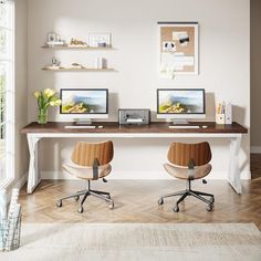 two computer desks sitting on top of a wooden floor