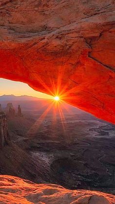 the sun is setting over canyons and mountains in this view from inside a cave