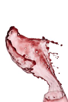 red liquid is pouring into a glass on a white background with space for the text