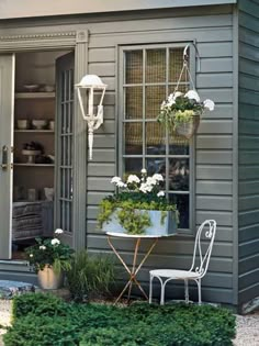 an outdoor patio with potted plants and chairs