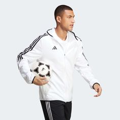 adidas Tiro 23 Men's League Windbreaker Born for the beautiful game. When the weather shows no intention of playing ball, zip up this adidas football windbreaker. Part of the Tiro 23 League range, it'll shrug off light showers and breezy conditions thanks to its woven, water-repellent shell. Its slim fit means you can pull it on over your jersey without sacrificing mobility. AEROREADY ensures you'll stay comfortable while it's on.Made with 100% recycled materials, this product represents just one of our solutions to help end plastic waste. Slim fit Full zip with lined hood 100% recycled polyester plain weave Mesh lining AEROREADY Side seam zip pockets Elastic cuffs and hem The Beautiful Game, Adidas Football, Play Ball, Plastic Waste, Nike Zoom, Product Label, Adidas Men, Water Repellent, North Face