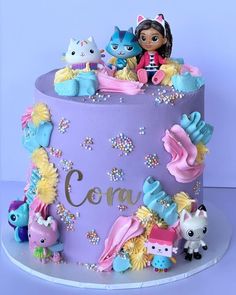 there is a cake decorated with toys on the top and letters that spell out confetti