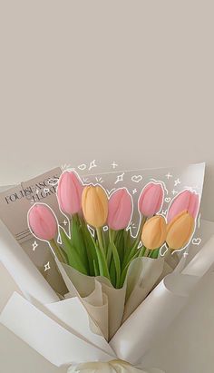 a bouquet of pink and yellow tulips wrapped in white paper with congratulations written on it