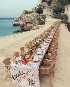 a long table is set up on the beach