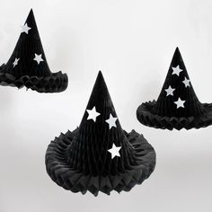 three black paper hats with white stars on them