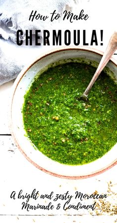 a bowl filled with green pesto next to a spoon