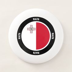 a white frisbee with a red and black cross on the front that says italy