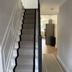 a staircase with carpeted steps leading up to the second floor