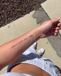 a person with a tattoo on their arm saying don't give up the day