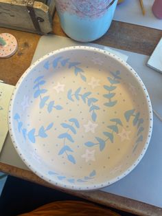 a blue and white bowl sitting on top of a table