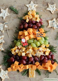 a christmas tree made out of cheese and grapes