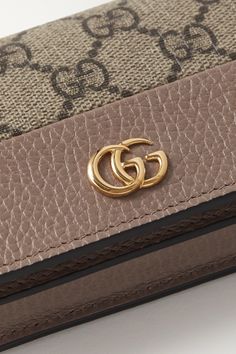 Gucci's wallet is ideally sized to slip into a clutch or coat pocket. Made from textured-leather and the house's iconic coated-canvas, it's decorated with a gold logo plaque and opens to reveal six card slots, a bill compartment and a zipped pocket. Brown Gucci Wallets With Interior Card Slots, Gucci Brown Wallets With Interior Card Slots, Gucci Gold Wallet On Chain With Gold-tone Hardware, Designer Travel Wallet On Chain With Gold-tone Hardware, Designer Wallet On Chain With Gold-tone Hardware For Travel, Luxury Gucci Clutch, Gucci Gold Wallet On Chain For Everyday Use, Designer Leather Wallet On Chain For Luxury, Gucci Gold Rectangular Wallet On Chain