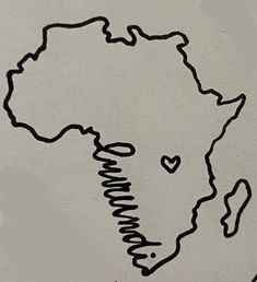 the outline of africa is drawn on a piece of paper with a heart in it