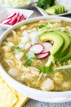 a white bowl filled with chicken and avocado soup