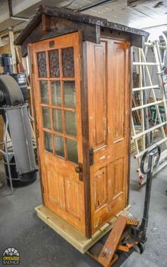 an old wooden phone booth is being worked on