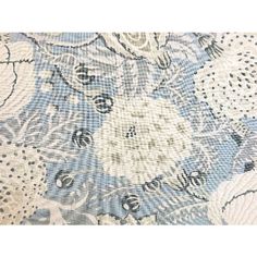 a blue and white floral print fabric with lots of small flowers on the bottom half of it