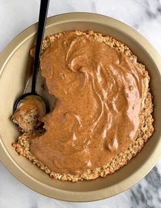 a bowl filled with peanut butter and oatmeal on top of a table