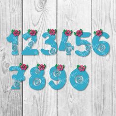 the numbers are decorated with pink flowers and green leaves on a white wooden background,