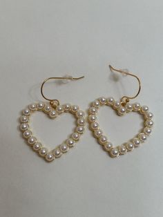 Open Heart Shaped Faux Pearl Dangling Pierced Earrings with 18kt Gold Plated Wires (Nickel Free) No Return on This Item The faux pearls are set in goldtone metal 1 3/4in drop, 1 3/8in W, 1 1/4in L The components were purchased and assembled by me. J83 Gold Hoop Earrings With Heart Charm For Party, Gold Open Heart Earrings For Party, Gold Dangle Heart Earrings For Party, Elegant Gold Earrings With Heart Beads, Valentine's Day Pearl Earrings For Party, Gold Pearl Earrings For Anniversary On Valentine's Day, Elegant Metal Earrings With Heart Beads, Gold Earrings With Heart Beads For Party, Metal Heart Earrings For Valentine's Day