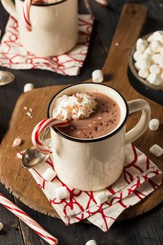 two mugs filled with hot chocolate and marshmallows