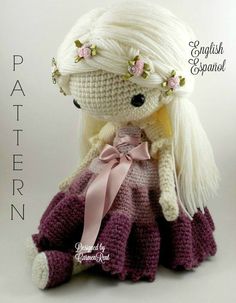 a crocheted doll is wearing a dress