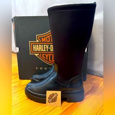 Harley-Davidson Women's Lenora 12-Inch Black Fashion Boots, Black-D84783. A Show Stopping Style That Is Ready For Anything, Measuring A Full 14-Inches From The Street To The Boot’s Collar. Greek For "Light", The Lenora Boot Boasts A Chunky, Yet Lightweight Outsole And Heel, Offering Both Style And The All-Day Comfort. The Shaft’s Stretch Fabric Allows For A Quick And Secure Fit While The Leather Provides Durability. Be Ready To Hit The Streets With Confidence! The Toe Is Smooth And Round, And Th Harley Davidson Boots For Women, Black Boots With Removable Insole And Round Toe, Black Slip-on Boots With Removable Insole, Black Closed Toe Boots With Removable Insole, Black Ankle-high Moto Boots With Rubber Heel Cap, Black Knee-high Moto Boots Medium Width, Black Ankle-high Boots With Removable Insole, Black High Ankle Waterproof Boots With Leather Sole, Black Moto Boots With Leather Sole And Medium Width