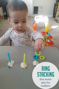 a toddler playing with plastic letters on the floor