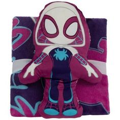 the spider - man plush toy is laying on top of a purple and blue blanket