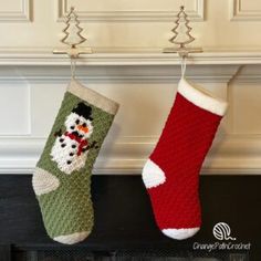 two christmas stockings hanging from hooks on a fireplace mantel, one with a snowman and the other with a santa clause