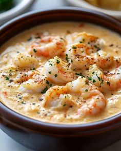 a bowl of soup with shrimp in it