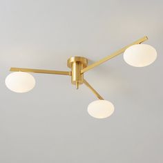 three light brass ceiling fixture with white globes