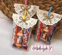 two small bags with candy in them sitting next to a basket filled with toothbrushes