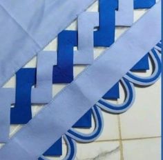 some blue and white strips on a tile floor with the word cut out in it