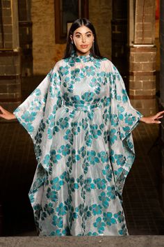 Turn heads in this mesmerizing floral Organza butterfly caftan dress, a true statement piece for the woman who loves to stand out. With its flowing butterfly sleeves and high neck design, this maxi-length beauty is perfect for black-tie events, luxurious resorts, or as an unforgettable wedding guest ensemble. Picture yourself twirling through a garden, or arriving at a fancy gathering with the vibrant floral gloss shimmering in the evening light. This dress is made for moments where elegance mee Organza Butterfly, Evening Light, Black Tie Gala, High Neck Designs, Floral Butterfly, Curvy Plus Size, Caftan Dress, Black Tie Event, Butterfly Sleeves