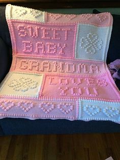 a crocheted blanket sitting on top of a couch