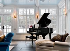 a living room filled with furniture and a grand piano