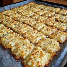 a pan filled with cheesy bread on top of a wooden table