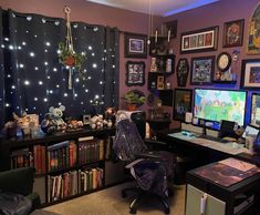 a computer desk sitting in front of a window filled with pictures and books on it