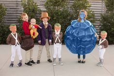 several children are dressed in costumes and holding fake heads