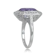 A geometric gemstone ring with a lively emerald cut natural kunzite with a pink saturation, weighing 7.22 carats. The center stone is bezel-set and surrounded by a halo of pave-set round brilliant-cut diamonds. Additional round brilliant cut diamonds are set along the shoulders, bringing the total diamond weight to approximately 0.53 carats. This ring was handcrafted in platinum and is decorated with an openwork under-gallery and fine milgrain.
The measurements of this ring, including the diamon Luxury Amethyst Ring With Emerald Cut Diamond, Luxury Emerald-cut Diamond Amethyst Ring, Luxury Emerald Cut Amethyst Ring With Diamond Setting, Luxury Octagon Ring With Bezel Setting, Luxury Octagon Sapphire Ring With Center Stone, Art Deco Diamond Ring With Baguette Cut Gemstone, Elegant Octagon Sapphire Ring With Bezel Setting, Art Deco Baguette Cut Gemstone Ring, Art Deco Octagon Ring With Center Stone