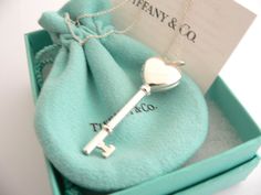 Offered for sale is a gorgeous Tiffany & Co. Sterling Silver Heart Key locket necklace. Hanging from its gorgeous Tiffany silver chain is a very pretty heart locket in the shape of a key - super cool piece! Perfect piece to store one or two pictures or keepsakes, and always keep them close to your heart! The necklace is a wonderful piece that is simple, elegant, and classic all rolled into one. It works perfectly with pretty much any attire your put on, AND adds a nice feminine touch to it. It i Heart-shaped Necklace With Two Keys For Gift, Elegant Heart-shaped Necklace With Two Keys, Elegant Heart-shaped Key Jewelry, Key Locket Necklace, Key Locket, Pretty Heart, Heart Key, Charm Chain, Heart And Key