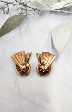 Amazing retro designed earrings, featuring red rubies and single cut diamonds set in 14k tri gold. Fourteen natural red rubies weigh ~0.60 carats Two 0.02 points of single cut diamonds Love the  folded fan  and shell like moteef. These are comfortable non pierced earrings 15.22 grams total weight Pre worn, in good condition Circa 1940's Art Deco Yellow Gold Earrings For Evening, Retro Yellow Gold Formal Earrings, Formal Art Deco Clip-on Earrings, Art Deco Yellow Gold Earrings For Anniversary, Art Deco Yellow Gold Anniversary Earrings, Vintage Clip-on Diamond Earrings For Anniversary, Art Deco Clip-on Earrings For Anniversary, Art Deco Anniversary Clip-on Earrings, Vintage Glamour