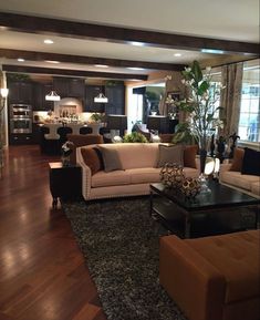 a living room filled with furniture and lots of windows