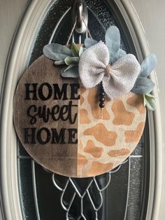 a door hanger that says home sweet home with a giraffe print design