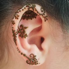 a close up of a person's ear with an intricate design on the side