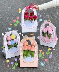 three boxes with flowers in them on the ground