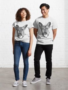 two people standing next to each other wearing t - shirts with an image of a dog on them