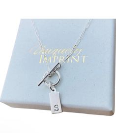 Sterling Silver Toggle Necklace                                   This is a all sterling silver toggle necklace with a tiny 14mm x 6mm personalized tag with the letter of your choice. Comes with a  18" mini paper clip chain. Please provide the following at checkout in message to seller box: -initial       Back of disc can't be stamped. To check out more personalized items from our shop please click here https://www.etsy.com/shop/UniquelyImprint Shipping/Production Times: We ship out in 1-3 busin New Bern, Toggle Necklace, Personalized Tags, Organza Bags, Name Necklace, Initial Necklace, Paper Clip, Initials, Jewelry Necklaces