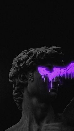 a statue with purple paint on it's face in the dark, next to a black background